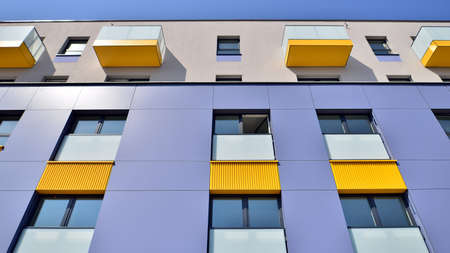Exterior of new apartment buildings on a blue cloudy sky background. No people. Real estate business...