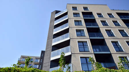 Exterior of new apartment buildings on a blue cloudy sky background. No people. Real estate business...