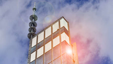 Modern glass facade against blue sky. Bottom view of a building in the business district. Low angle...