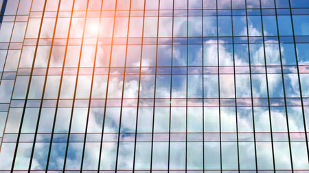 Architecture details. Modern glass building facade in sunny day. Business background.