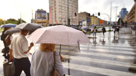 Szczecin, Poland. 29 August 2022. People with umbrellas on a rainy day outside