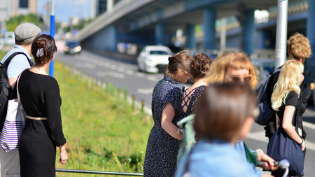Warsaw, Poland. 10 August 2022. People of different ages and with comfortable clothes crossing the road through. View of a city street with residents, tourists and buildings.のeditorial素材