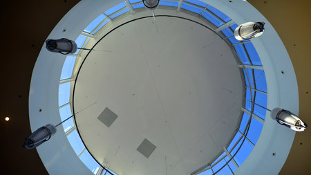 An interior dome ceiling with lightings. Internal view of inside shopping center mall.