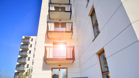 New apartment building on a sunny day. Modern residential architecture. The apartment is waiting for new residents.の写真素材
