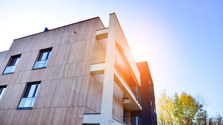 New apartment building on a sunny day. Modern residential architecture. The apartment is waiting for new residents.の写真素材