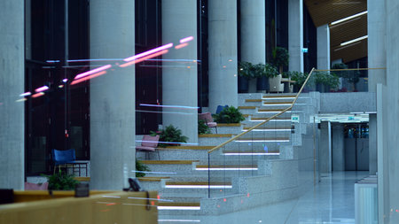 Warsaw, Poland. 23 November 2022. Evening city life in the center of Warsaw. Large windows of the lobby of an Skyliner office building and empty corridor in the modern office buildのeditorial素材
