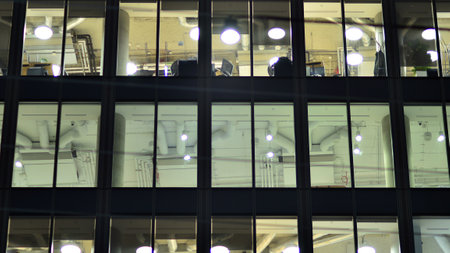 Modern office building in the city at the night. View on illuminated offices of a corporate...