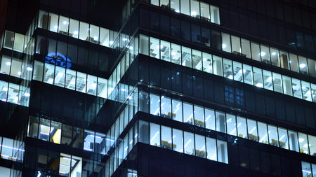 Modern office building in the city at the night. View on illuminated offices of a corporate...
