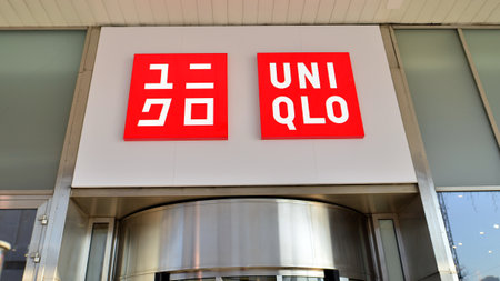 Warsaw, Poland. 14 December 2022. Winter street of a big city. Sign UniQlo. Company signboard Uni Qlo.のeditorial素材