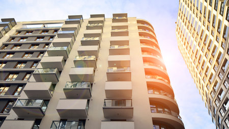 The narrow passage between modern residential buildings. Walls of high-rise apartment buildings and...
