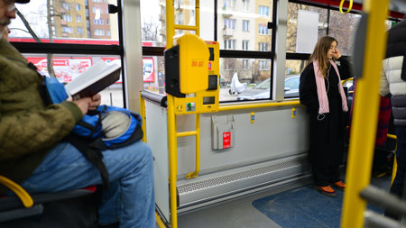 Warsaw, Poland. 19 January 2023. Interior of city bus. Passengers in the city bus. Modern public transport is convenient for travelers.のeditorial素材