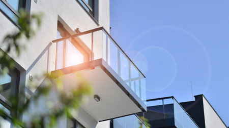 eco architecture. Green tree and new apartment building. The harmony of nature and modernity. Modern residential building with new apartments in a green residential area.の写真素材