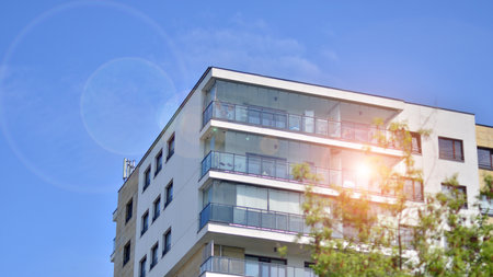 eco architecture. Green tree and new apartment building. The harmony of nature and modernity. Modern residential building with new apartments in a green residential area.の写真素材