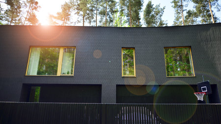 Upscale house in a wooded area. Fragment of a single-family house facade.