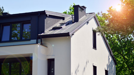 Terraced family homes in a newly developed housing estate. The real estate market in the suburbs. New single family houses in a new development area. Residential homes with modern faの写真素材