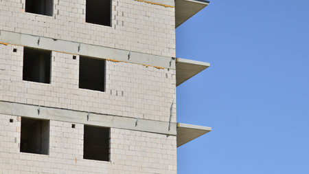 Residential building under construction. Building under construction against blue sky