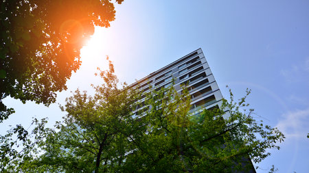 Modern residential building with new apartments in a green residential area. Eco architecture. Green...