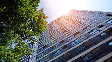 Modern residential building with new apartments in a green residential area. Eco architecture. Green...
