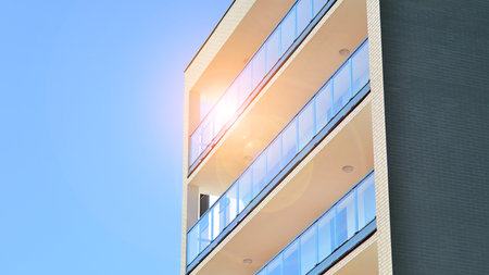 Modern luxury residential building. Modern apartment building on a sunny day. Facade apartment building with a blue sky.の写真素材