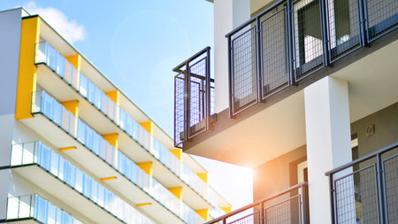 Modern luxury residential building. Modern apartment building on a sunny day. Facade apartment building with a blue sky.の写真素材
