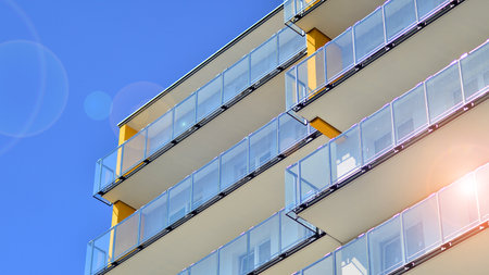 Modern luxury residential building. Modern apartment building on a sunny day. Facade apartment building with a blue sky.の写真素材