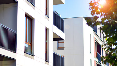 Green community. Eco apartment building saving energy and fresh air concept. Block of flats in...