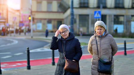 Warsaw, Poland. 29 December 2023. People of different ages and nationalities walk across in the city...