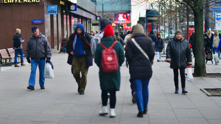 Warsaw, Poland. 29 December 2023. People of different ages and nationalities walk across in the city center, winter time. People on the street.のeditorial素材
