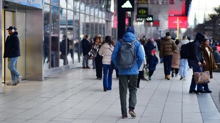 Warsaw, Poland. 29 December 2023. People of different ages and nationalities walk across in the city center, winter time. People on the street.のeditorial素材