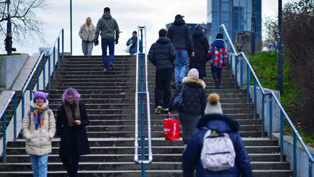 Warsaw, Poland. 29 December 2023. People of different ages and nationalities walk across in the city...
