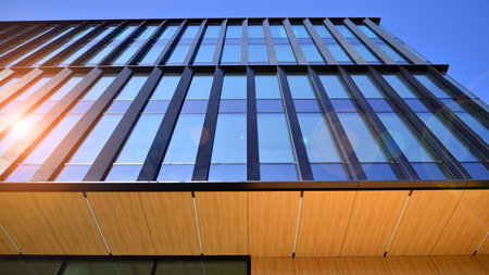 Modern office building with glass facade. Transparent glass wall of office building. Reflection of...