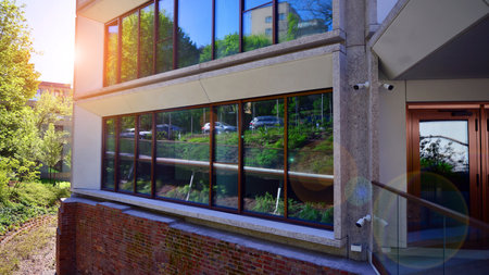 Eco architecture. Green tree and new residential building. Harmony of nature and modernity. Modern...