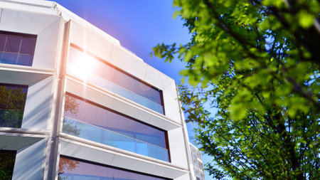 Eco architecture. Green tree and new residential building. Harmony of nature and modernity. Modern...