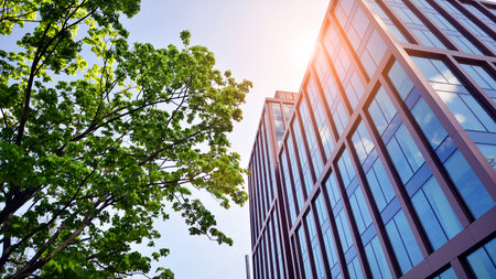 Eco building in modern city concept. Modern office building with the fresh green leaves.
