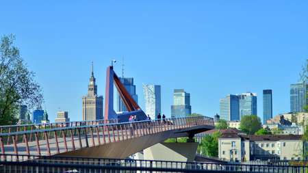 Warsaw, Poland. 11 April 2024. Bridge over the Vistula River intended only for pedestrians and cyclists. In the background, a panorama of the city with skyscrapers.のeditorial素材
