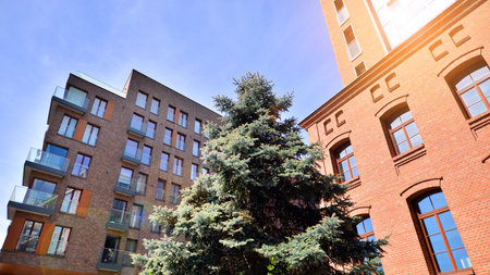 Modern residential building with new apartments in a green residential area. Eco architecture. Green...