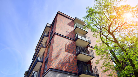 Modern residential building with new apartments in a green residential area. Eco architecture. Green...