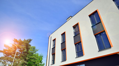Sustainable glass office building with trees for reducing carbon dioxide. Eco-friendly building in...