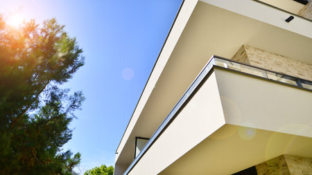 Eco-friendly living in city with greens. Eco apartment building saving energy and fresh air concept.の写真素材
