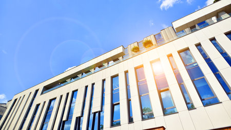 Bottom view of modern skyscrapers in business district against blue sky. Looking up at business buildings in downtown.の写真素材