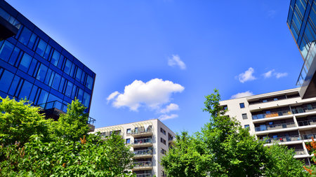 Sustainable glass office building with trees for reducing carbon dioxide. Eco-friendly building in...
