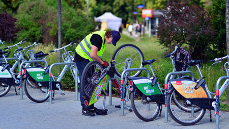 Warsaw, Poland. June 8, 2024. Bike station by Veturilo company. A technician repairs bikes. Technical inspection of bicyclesのeditorial素材