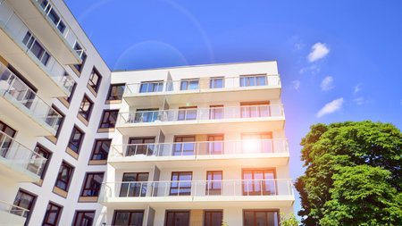 European residential architecture harmonizing with nature. Eco-friendly living in city with greens. Eco apartment building saving energy and fresh air concept.の写真素材