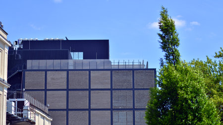 Exterior of a modern industrial building with green environment. Corporate building reduce CO2. Eco...