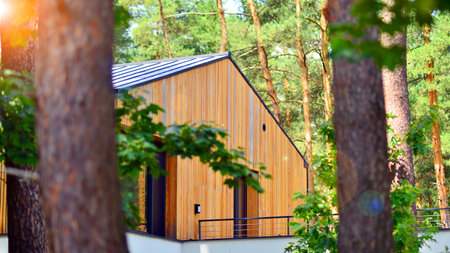 Upscale house in wooded area. Fragment of a single-family house facade.の写真素材