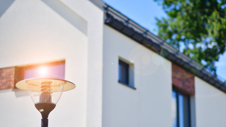 Terraced single family homes in newly developed housing estate. The real estate market in the suburbs with lush greenery surrounding. Harmony with nature, eco architecture.の写真素材