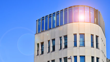 A fragment of the glass and sandstone facade of a modern office building. Wide abstract fragment of modern building facade. View of modern glass and stone facade.の写真素材
