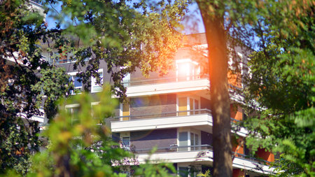 Eco apartment building saving energy and fresh air concept. European residential architecture harmonizing with nature. Eco-friendly living in city with greens.の写真素材