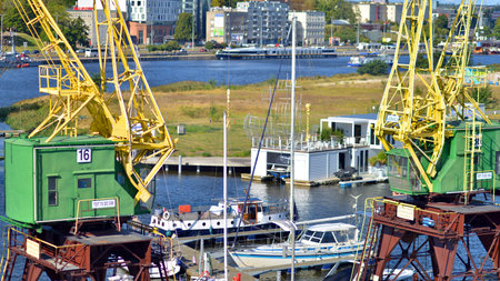 Szczecin, Poland. 14 September 2024. Landscape view and ships on the Odra river and old cranes