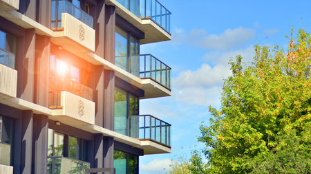 Eco apartment building saving energy and fresh air concept. European residential architecture harmonizing with nature. Eco-friendly living in city with greens.の写真素材